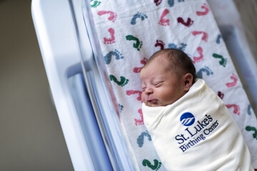 A newborn in their sleep sack